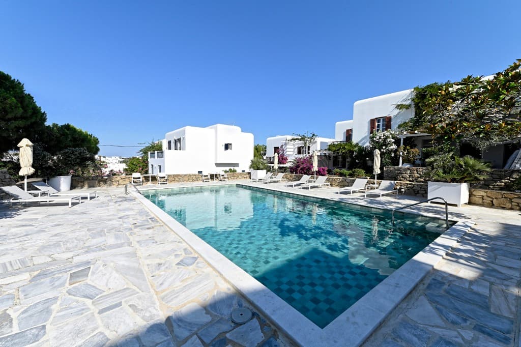 View along the shared pool deck, bougainvillea, and apartment buildings in the complex